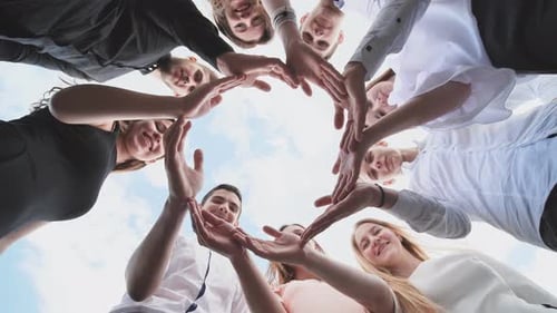 A Group of High School Students Look Through the Shape of a Circle Created From Their Palms