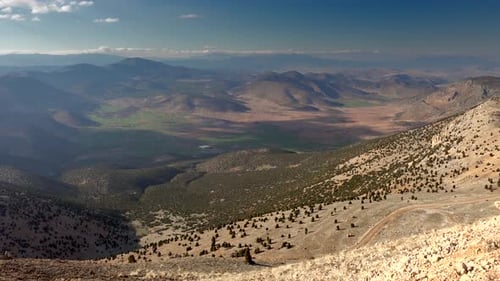 View From Mountain Peak to Small Plain Between Mountains