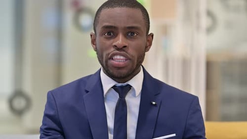 Young Adult Man Pointing and Talking at Camera