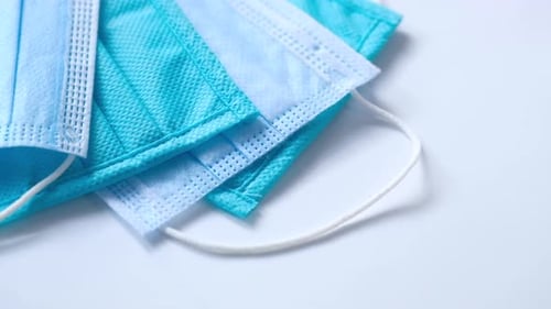 Close Up of Blue Surgical Masks on Table
