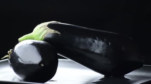 Fresh Eggplants Still Life on Black Background