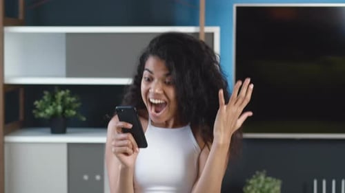 Excited Young Woman Reacts to News on Phone