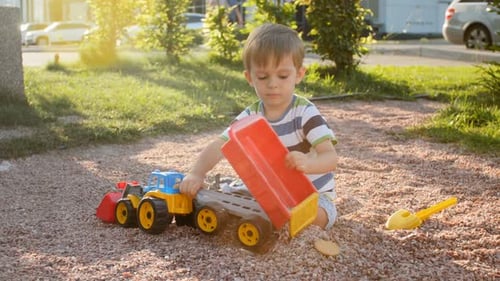 Cute 3 Years Old Toddler Boy Playing on Playground at Park at Sunset