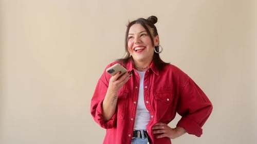 Woman Sends Voice Message on Smartphone Indoors
