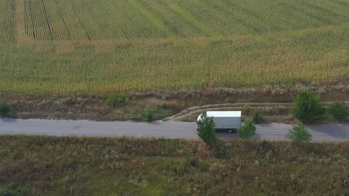 Aerial Shot of Truck with Cargo Trailer Driving on Road and Transporting Goods. Flying Over Delivery