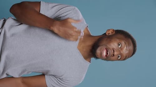 Man Gesturing and Speaking in Vertical Studio Shot