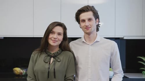 Smiling Couple Standing in Modern Kitchen