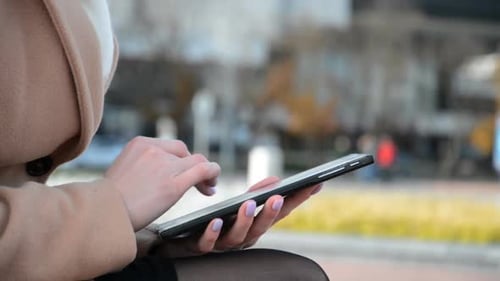 Business Woman Writes a Message on a Tablet