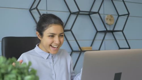 Close-Up Portrait Of A Young Indian Woman, Successfully Looking At The Monitor Screen, Luck Winning
