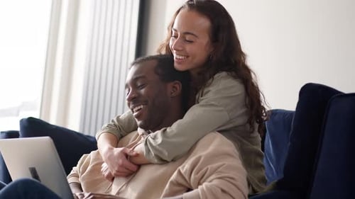 Happy Couple Relaxing Together at Home on Couch