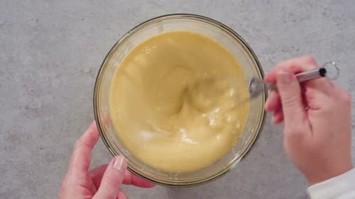 Top View Stirring Batter With Whisk in Bowl