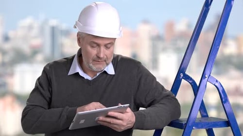 Mature Engineer Working on Pc Tablet.