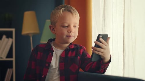 Child Talks on Smartphone During a Video Call