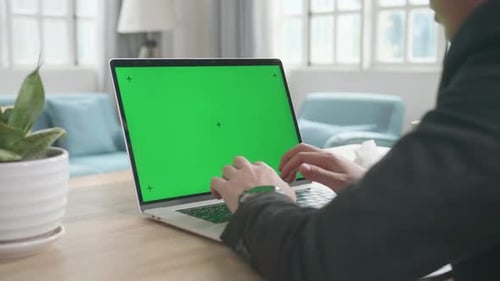 Asian Businessman Typing On Green Screen Computer While Working At Home