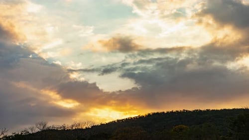 Dramatic Clouds at Sunrise or Sunset Over Hills