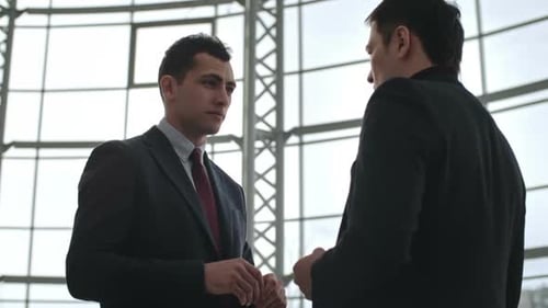 Businessmen Discussing Ideas in Modern Office Building