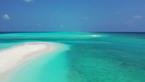 Aerial scenery of exotic resort beach adventure by shallow ocean with white sand background of a day