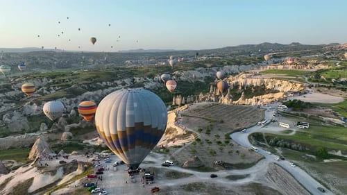 4K Aerial view of Goreme. Colorful hot air balloons fly over the valleys.