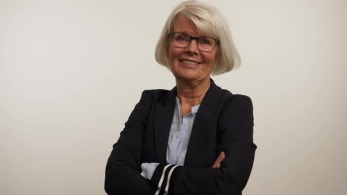 Smiling Mature Woman Puts On Glasses and Poses