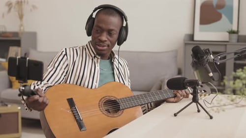 Male African-American Guitarist Having Live Stream