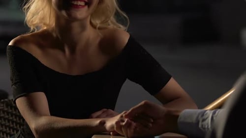 Couple Sitting at Table at Terrace Female Giving Her Hand to Male Flirting