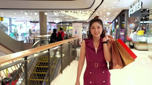 Stylish Woman Walking in Modern Shopping Mall