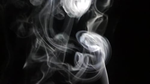 Gray Smoke Wisps Flowing on Black Background