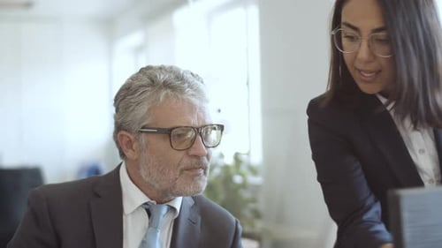Focused Female Assistant Explaining Paper Details