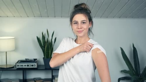 Woman With Bandage Smiles and Gives Thumbs Up