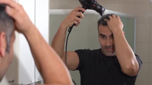 Hair styling with a blow dryer.
