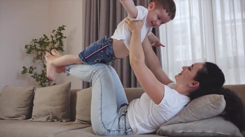 Mother and Child Play Airplane Together