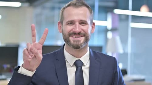 Cheerful Man in Suit Makes Peace Sign