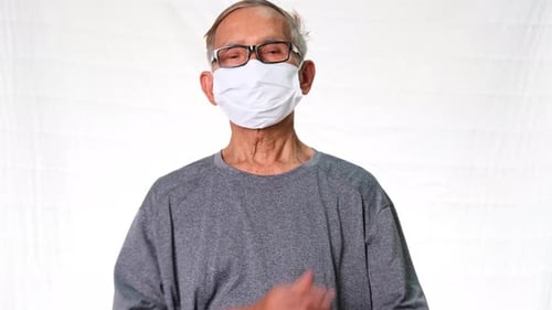 Senior Man Wearing Face Mask with Arms Crossed