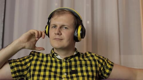 Man Enjoying Music with Headphones Indoors