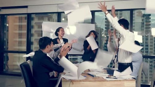 Business Team Celebration Tossing Papers in Office