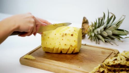 Close up of Person Peeling Fresh Pineapple