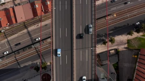 Aerial Birds Eye Overhead Top Down View of Traffic on Highway Bridge Leading Over Street and Railway
