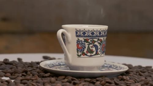 Steaming Cup of Coffee Close Up with Beans