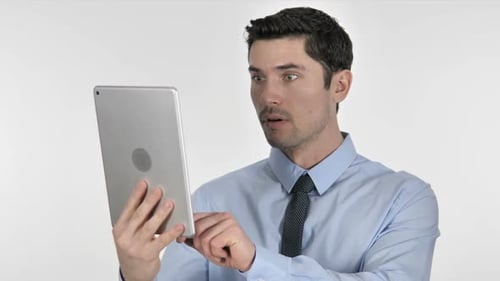 Man Expressing Shock While Using Tablet