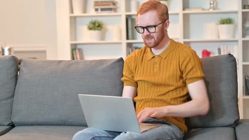 Young Man Using Laptop Experiences Back Pain