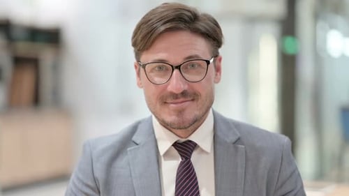 Man in Suit Smiling in Office