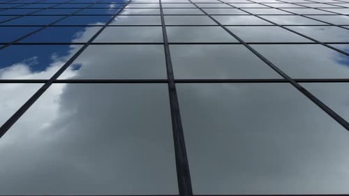 Infinite Plane Perspective of Reflective Building with Timelapse Clouds