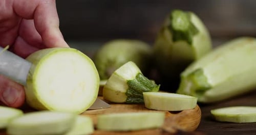 Men Hands Cut Zucchini Into Round Slices