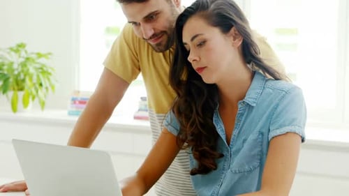 Couple Using Laptop Together at Home During the Day