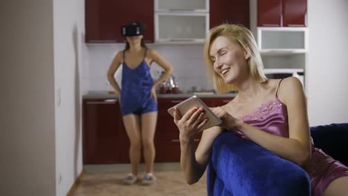 Women Relaxing at Home With VR Headset and Tablet