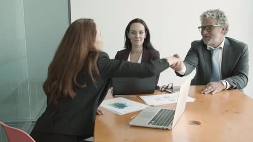 Business Handshake in a Conference Room