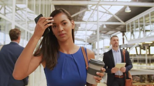 Businesswoman Walking with Coffee in Modern Office