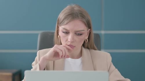 Close Up of Businesswoman Thinking While Working on Laptop in Office