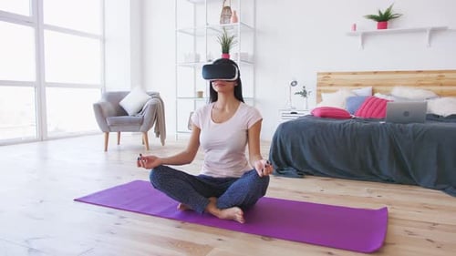 Woman Meditating with VR Headset in Bedroom