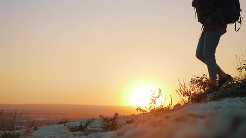 Silhouetted Hiker Walking at Sunrise